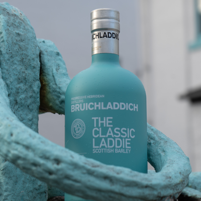 Bruichladdich whisky bottle with a silver cap on a textured surface