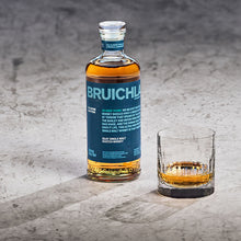 Load image into Gallery viewer, Bruichladdich 18 year old whisky bottle and glass on a textured surface