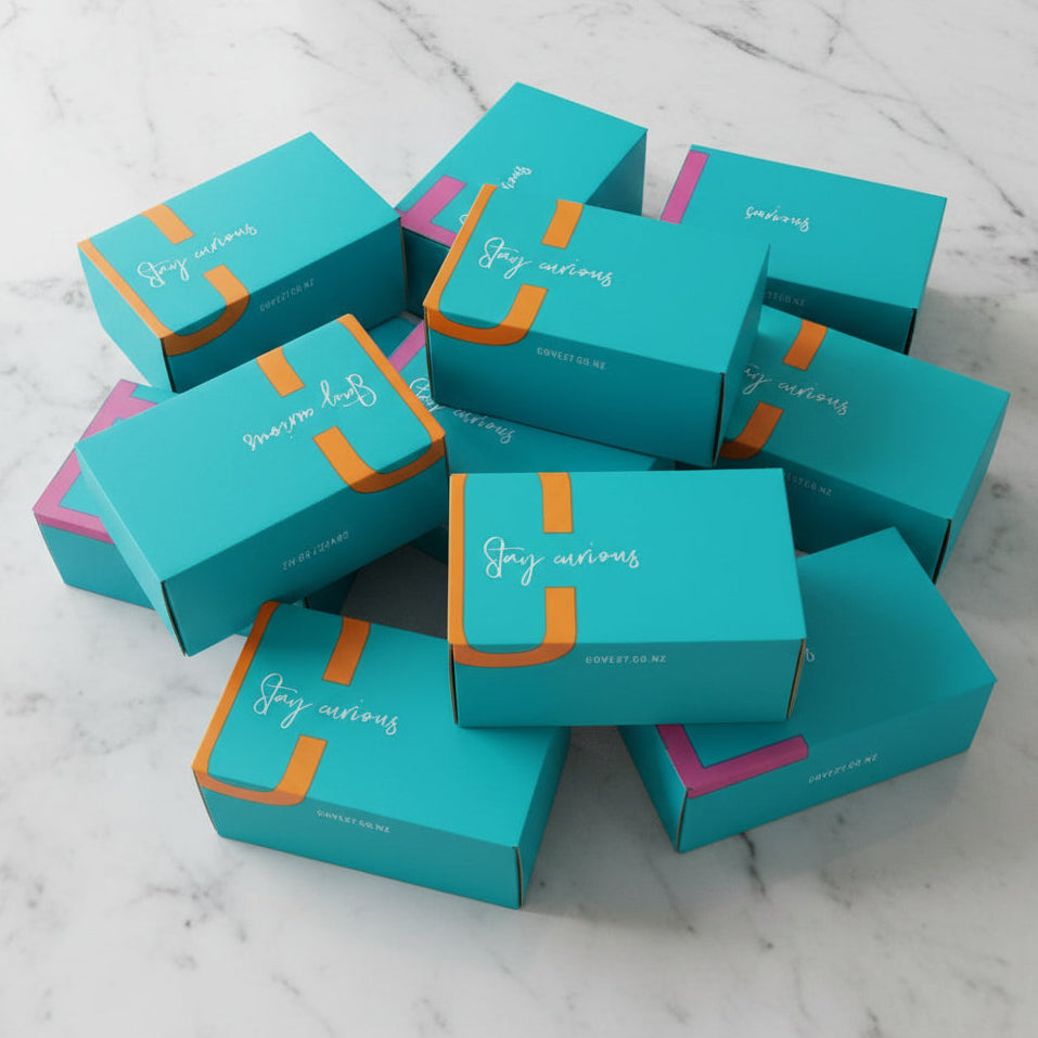 Load image into Gallery viewer, COVE27 Premium Packaging boxes with pink and orange accents on a marble surface