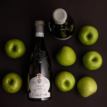 Load image into Gallery viewer, Bottle of Fratelli Calzoni wine with green apples on a dark surface