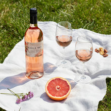 Load image into Gallery viewer, Bottle of Cable Bay Pinot Noir Rosé with two glasses and a half-grapefruit on a white blanket outdoors.