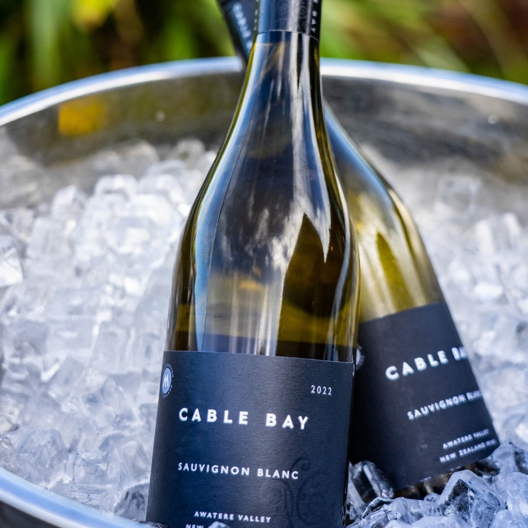 Load image into Gallery viewer, A couple of bottle of Cable Bay Cinders Vineyard Sauvignon Blanc white wines in an ice bucket 