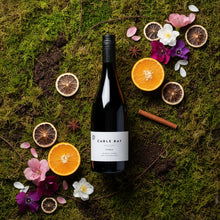 Load image into Gallery viewer, Bottle of Cable Bay Reserve Syrah wine surrounded by fruits, flowers, and spices on a mossy background