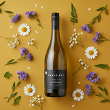 Load image into Gallery viewer, A bottle of Cable Bay Waiheke Island Chardonnay on a yellow background surrounded by flowers