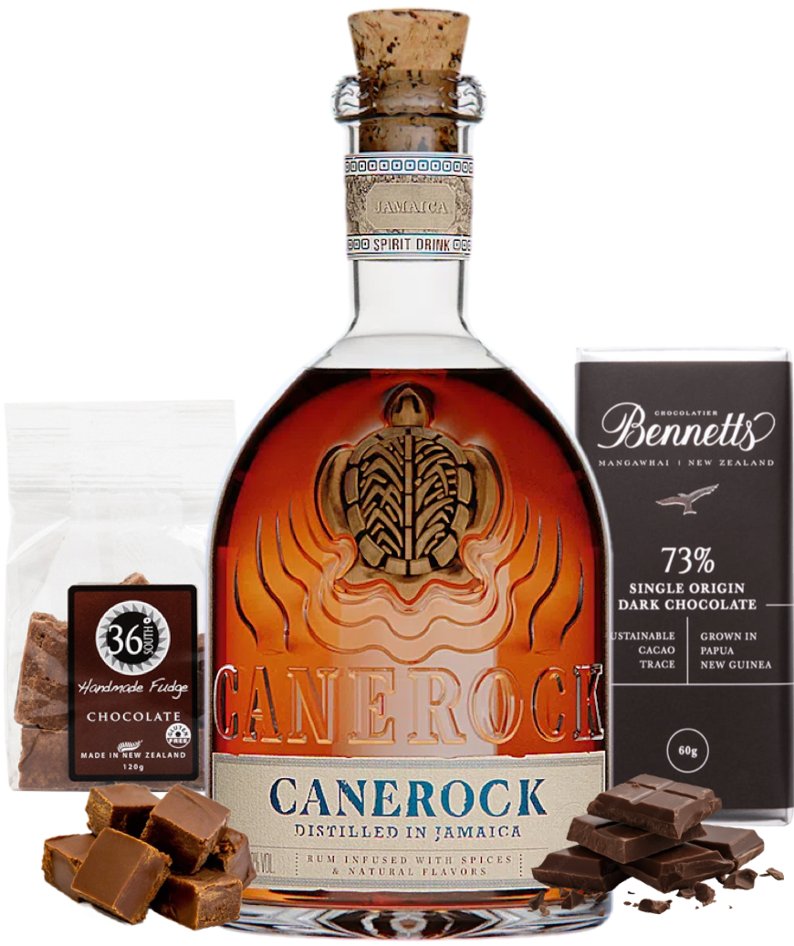 Load image into Gallery viewer, A bottle of Canerock Jamaican Spiced Rum, displayed with a bag of 36 Degrees Handmade Chocolate Fudge, a dark Bennett's chocolate bar, and chocolate pieces on a white background.