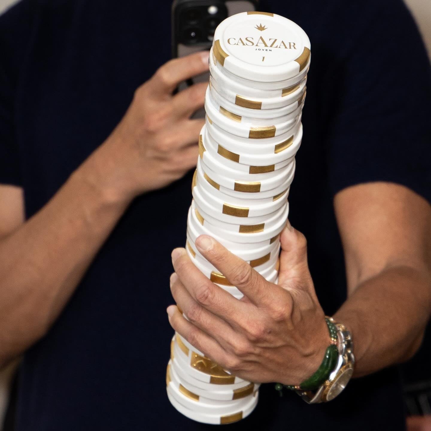 Load image into Gallery viewer, A man holding a bottle of CasAzar Joven Tequila.