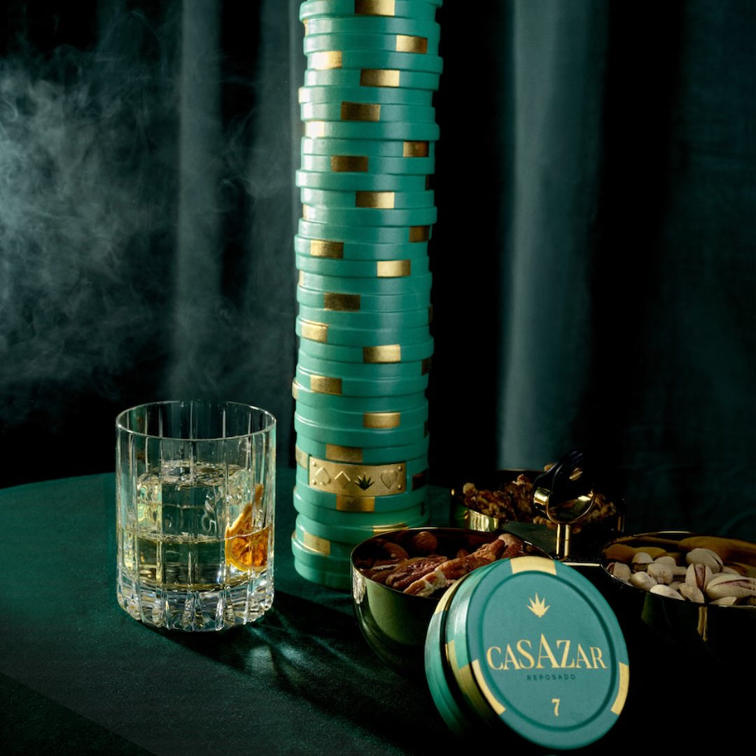 Load image into Gallery viewer, A bottle of CasAzar Reposado Tequila with a glass of tequila and a bowl on a dark background