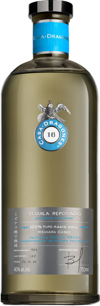 A bottle of Casa Dragones Reposado Mizunara Tequila, featuring a clear glass bottle with a golden-amber liquid, a black cap, a blue neck label, and a grey lower label with the brand's eagle logo.