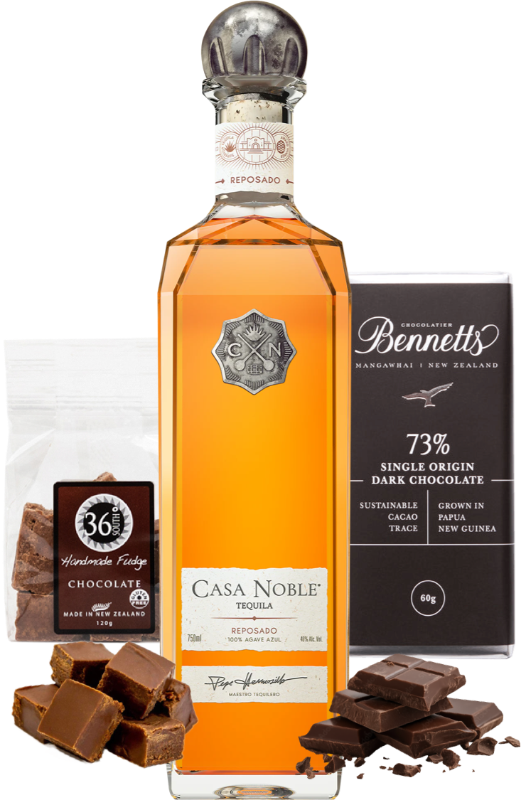 Load image into Gallery viewer, A bottle of Casa Noble Reposado Tequila centered on a white background, flanked by a bag of 36 Degrees Handmade Chocolate Fudge and a bar of Bennett's 73% Single Origin Dark Chocolate, with chocolate pieces scattered at the base