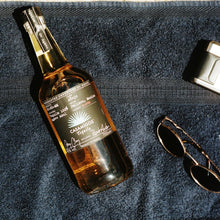 Load image into Gallery viewer, Bottle of Casamigos Anejo Tequila on a towel with sunglasses and a wallet