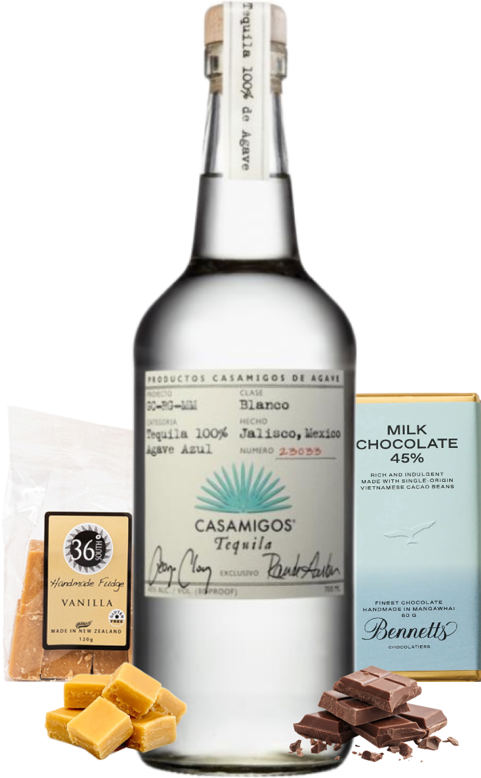 Load image into Gallery viewer, Casamigos blanco tequila bottle with vanilla candy, chocolate, and a box of milk chocolate on a white background
