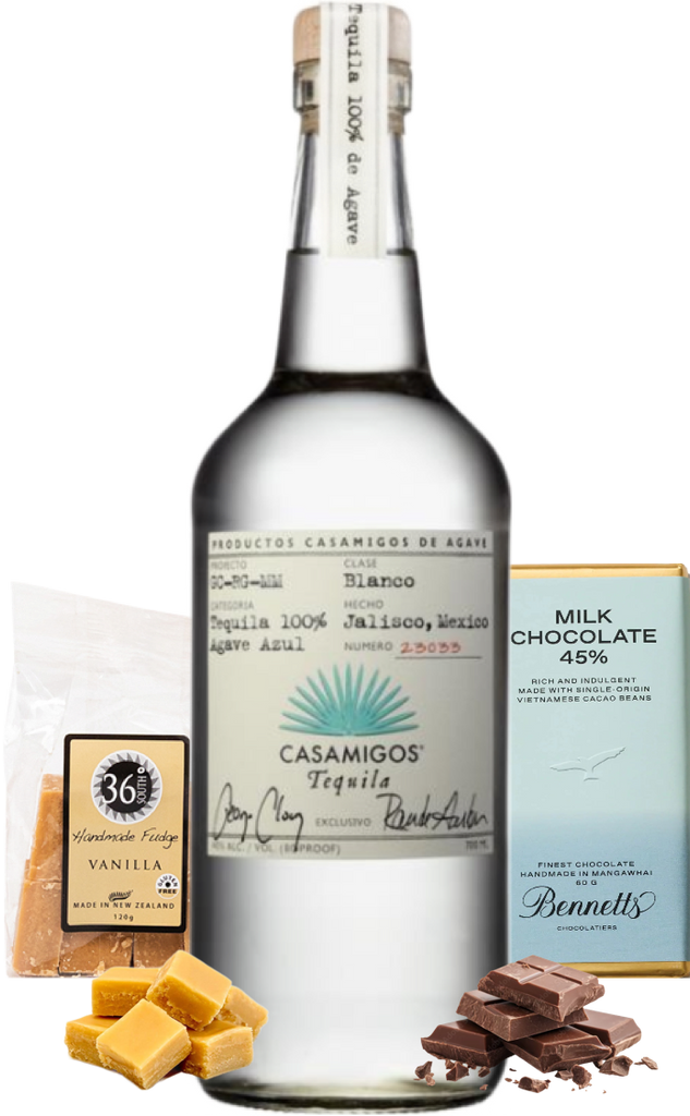 Casamigos blanco tequila bottle with vanilla candy, chocolate, and a box of milk chocolate on a white background