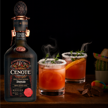 Load image into Gallery viewer, Cenote tequila bottle with two cocktails on a wooden surface