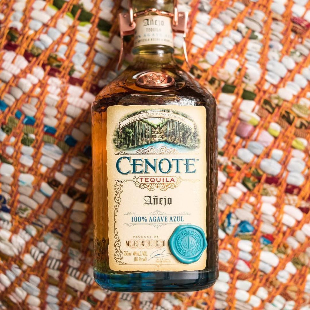 Cenote Tequila bottle on a textured orange and white background