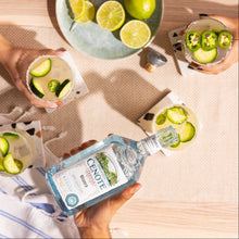 Load image into Gallery viewer, Cenote Blanco Tequila bottle with cocktails and limes on a wooden table