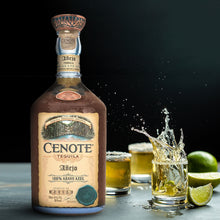 Load image into Gallery viewer, Cenote tequila bottle with a glass of tequila and lime on a dark background