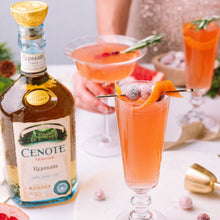 Load image into Gallery viewer, Cenote Reposado tequila bottle with cocktails on a table