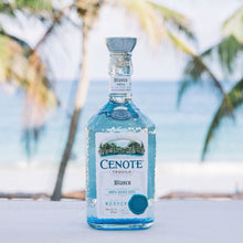 Load image into Gallery viewer, Cenote Tequila bottle with palm trees and ocean in the background