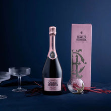 Load image into Gallery viewer, Bottle of Charles Heidsieck Rosé Reserve champagne with packaging on a dark blue background