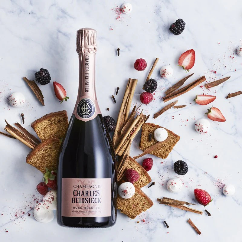 Load image into Gallery viewer, Bottle of Charles Heidsieck champagne surrounded by berries, cookies, and spices on a marble surface