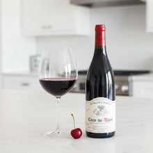 Load image into Gallery viewer, Bottle of Charvin Cotes du Rhone wine wine with a glass and cherry on a kitchen counter.