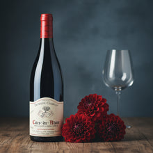 Load image into Gallery viewer, Charvin Cotes du Rhone wine red wine bottle with a label, accompanied by red flowers and an empty glass on a wooden surface.