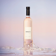 Load image into Gallery viewer, Bottle of Minuty Rosé wine with a soft gradient background