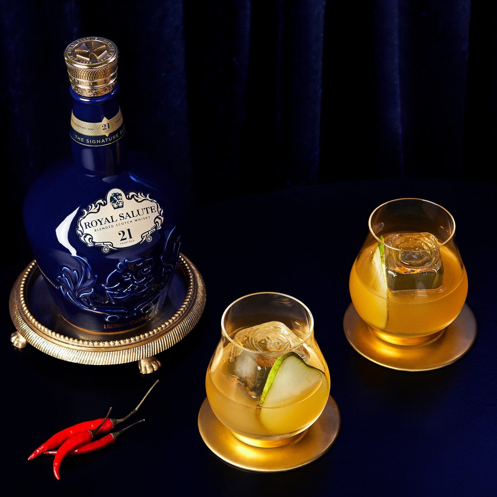 Load image into Gallery viewer, Bottle of Chivas Regal Royal Salute 21 Year Old Signature Blend Scotch Whisky on a dark background with two glasses of whiskey.