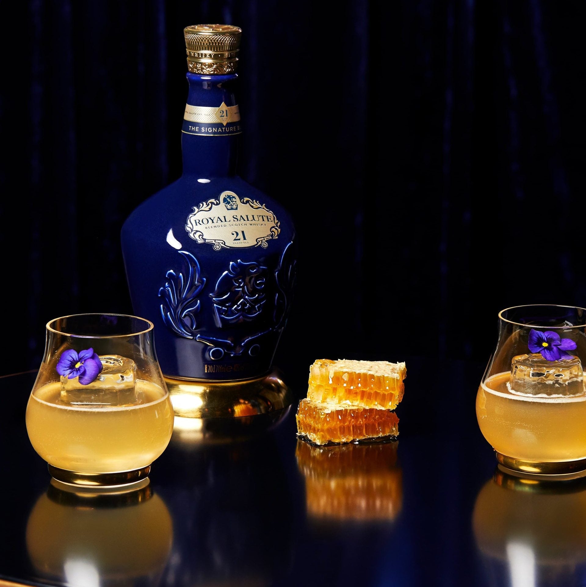 Load image into Gallery viewer, Bottle of Chivas Regal Royal Salute 21 Year Old Signature Blend Scotch Whisky with two glasses of yellow liquid on a dark surface.
