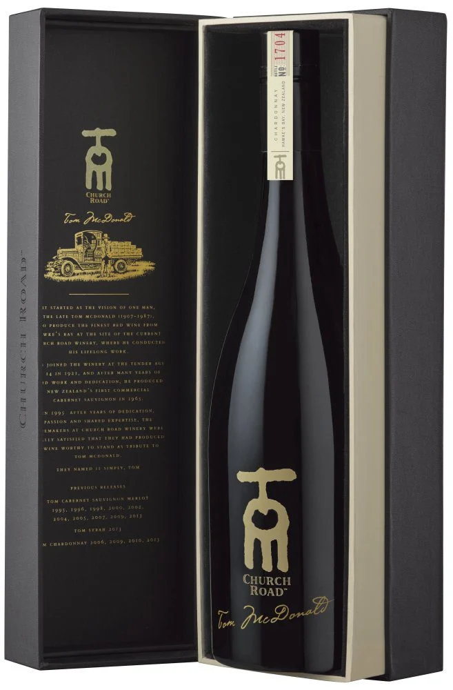 Load image into Gallery viewer, Black bottle of Church Road TOM Chardonnay wine in a decorative box with gold logo and text.