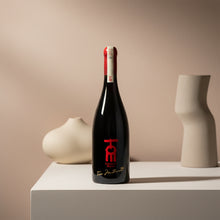 Load image into Gallery viewer, Church Road TOM Syrah-style wine bottle with a red label on a beige surface with decorative vases.