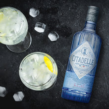 Load image into Gallery viewer, Citadelle gin bottle with two glasses of gin and tonic on a dark surface