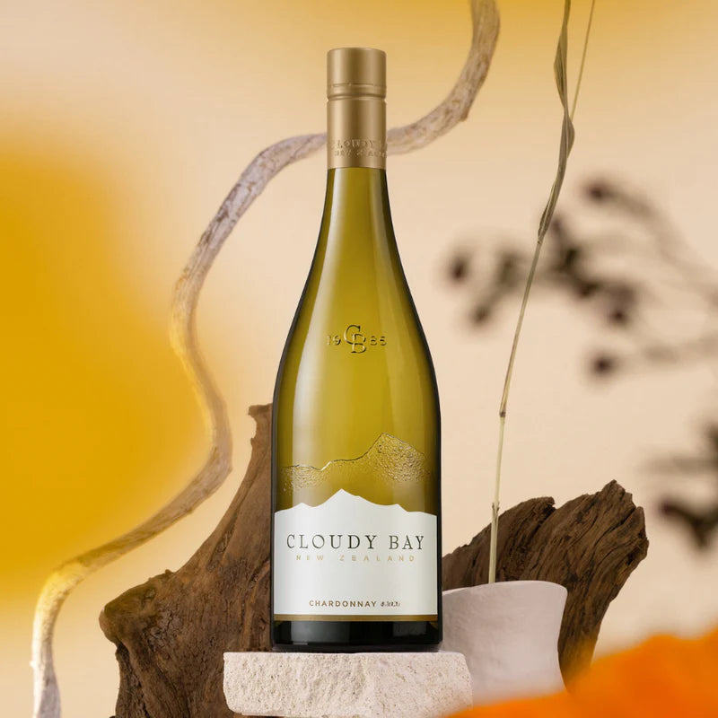 Load image into Gallery viewer, A bottle of white on a white rock with twigs behind it 