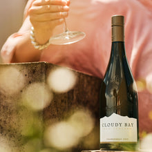 Load image into Gallery viewer, Bottle of Cloudy Bay Chardonnay with a person holding a glass in the background