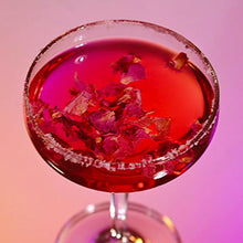 Load image into Gallery viewer, Cocktail with edible dried flowers in a glass against a gradient background