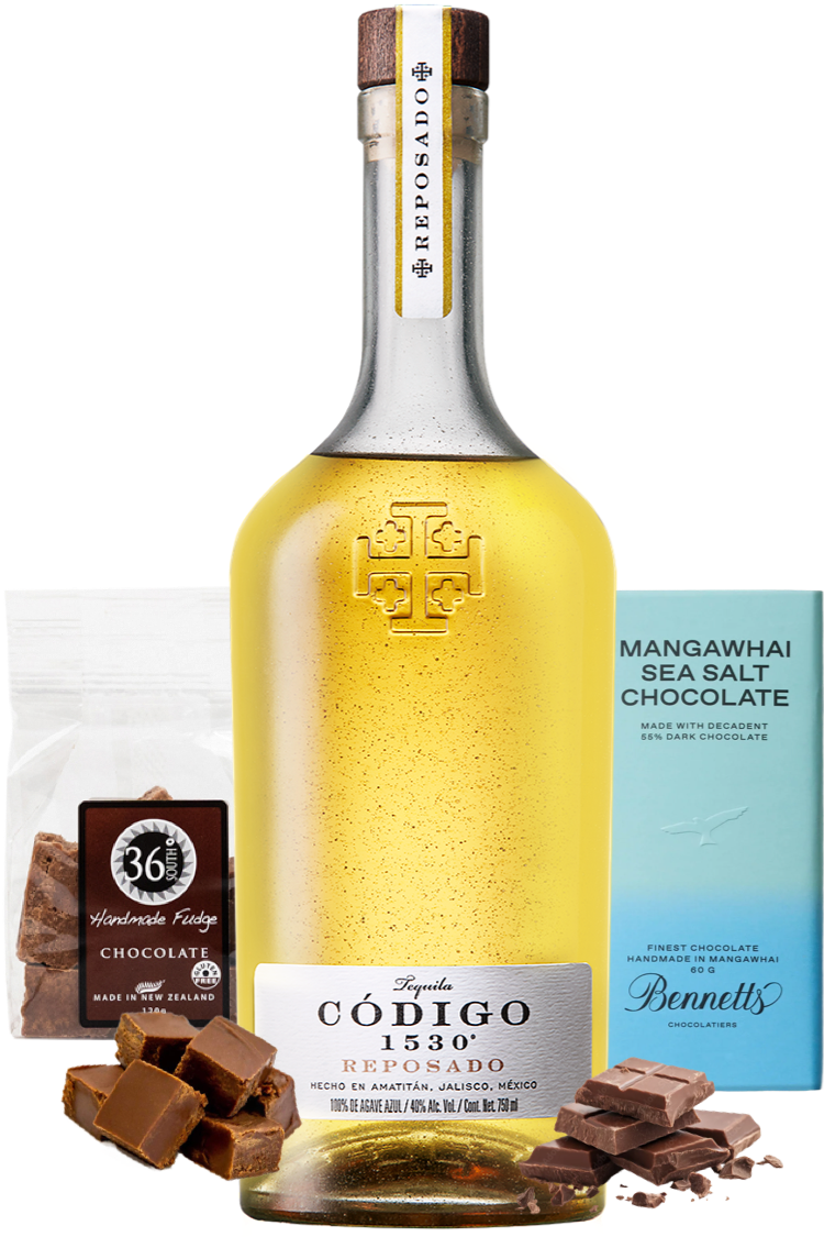 Load image into Gallery viewer, Bottle of Código 1534 Reposado Tequila with chocolate pieces and a box of Bennett's chocolate.