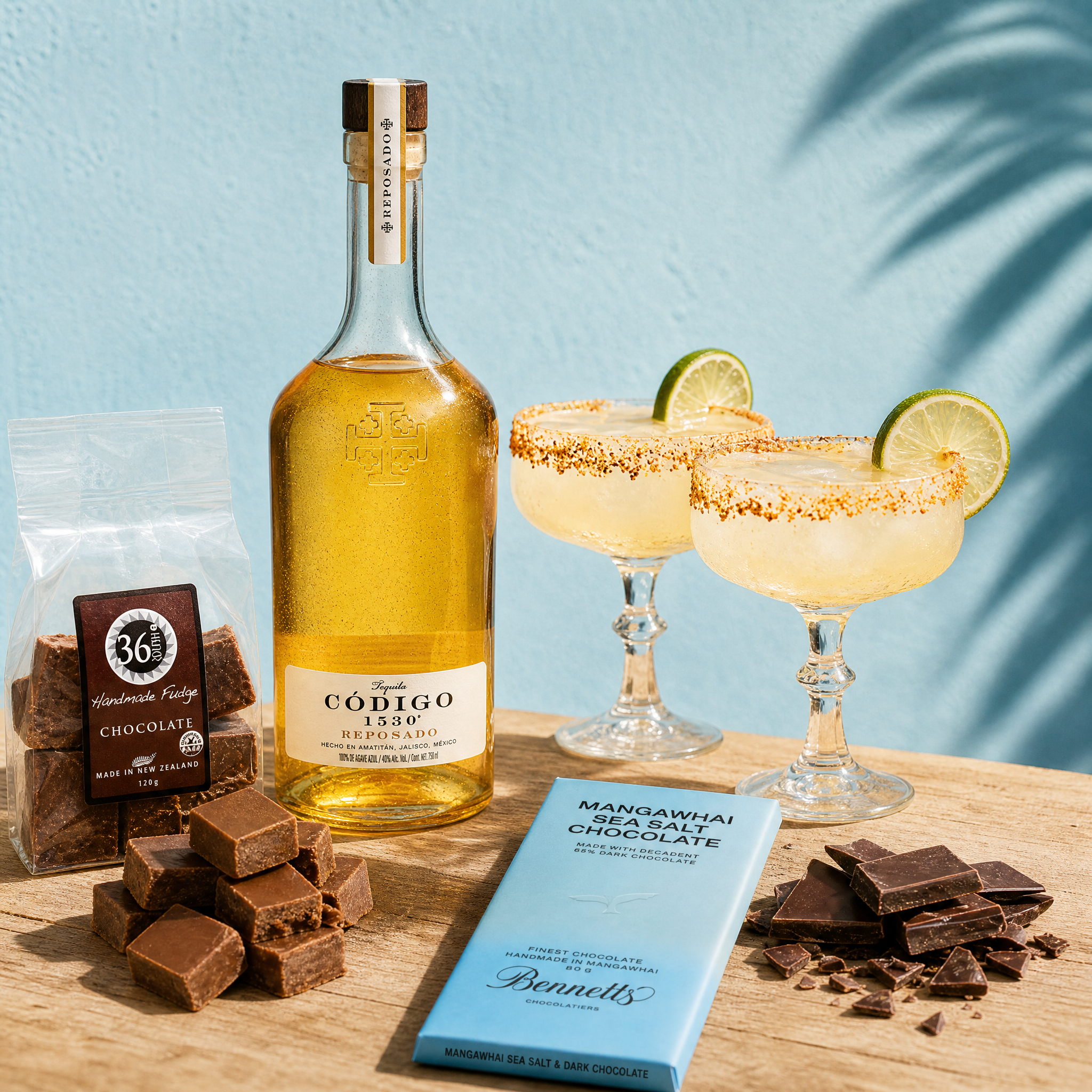 Load image into Gallery viewer, Bottle of Código Reposado tequila with chocolate fudge, chocolate bars, and cocktails on a wooden surface.