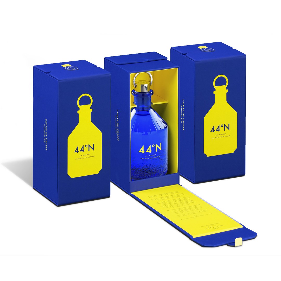 Load image into Gallery viewer, Bottles of Comte de Grasse 44 degrees N Gin in a blue and yellow gift box on a white background