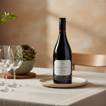Load image into Gallery viewer, Bottle of Craggy Range Syrah wine on a table with glasses and decor