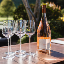 Load image into Gallery viewer, Wine bottle and glasses on a wooden table with a blurred natural background