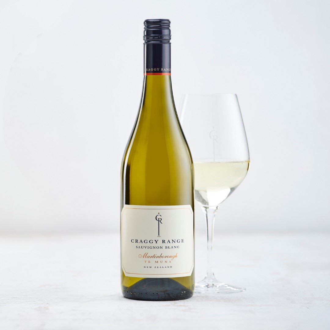 Load image into Gallery viewer, A bottle of white wine and a glass on a white table on a white background