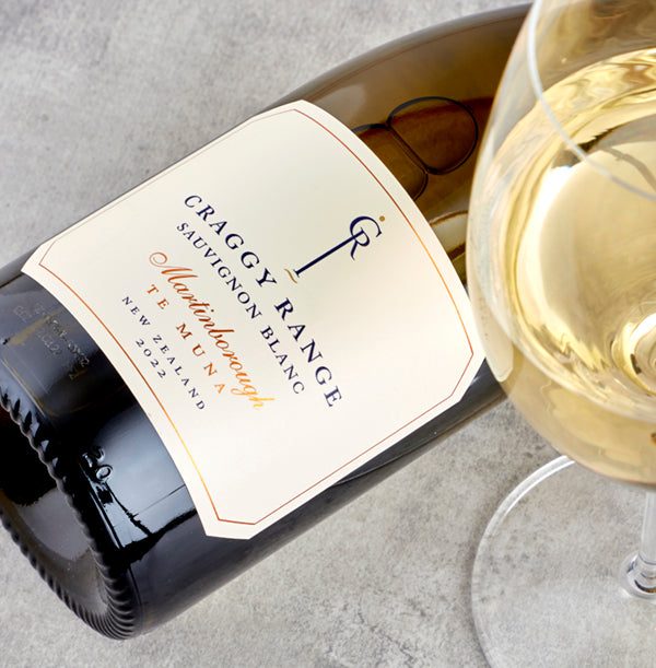 Load image into Gallery viewer, A bottle of white wine and glass on a grey table