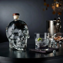 Load image into Gallery viewer, Crystal skull bottle with a cocktail on a bar counter
