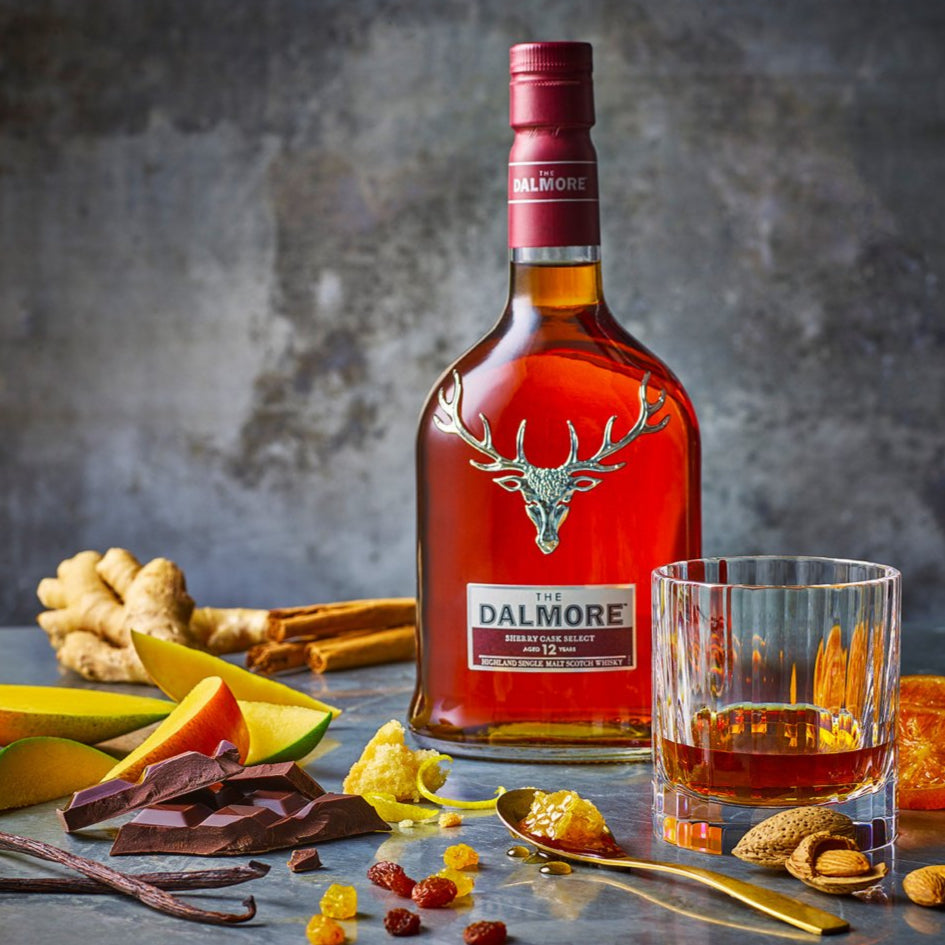 Dalmore whisky bottle with a glass of whisky on a table with ingredients