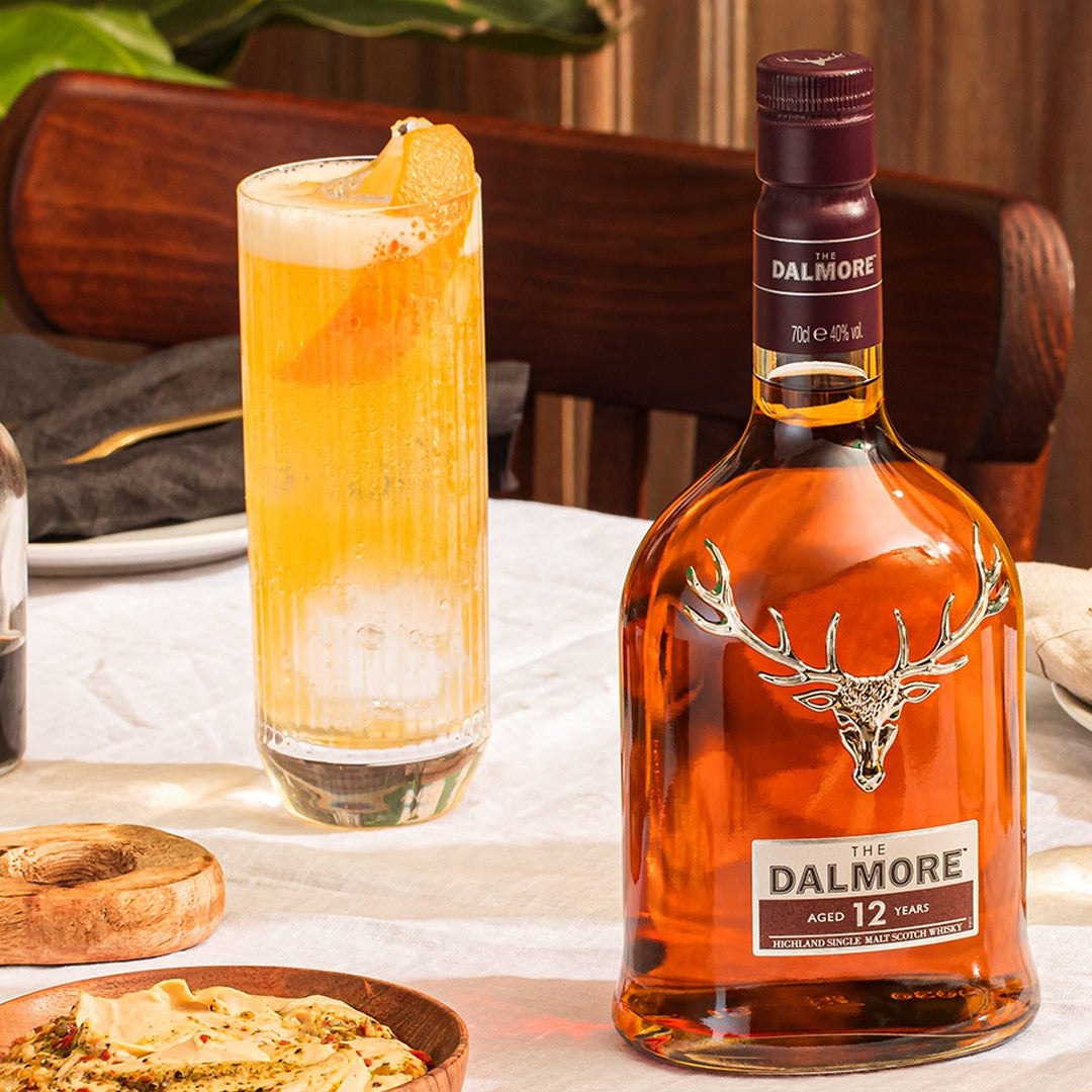 Load image into Gallery viewer, Dalmore 12 year old whisky bottle with a cocktail on a dining table