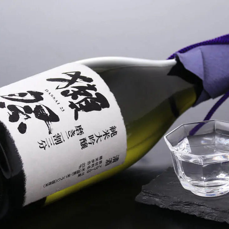 Load image into Gallery viewer, Sake bottle with a small cup on a dark surface