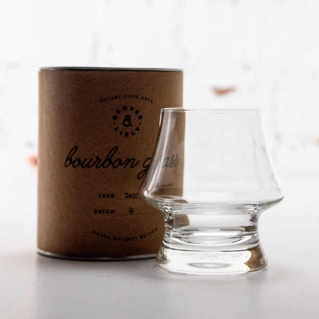 Load image into Gallery viewer, Clear Denver and Liely Bourbon Glass next to a brown cardboard box labeled 'bourbon glass' on a white background