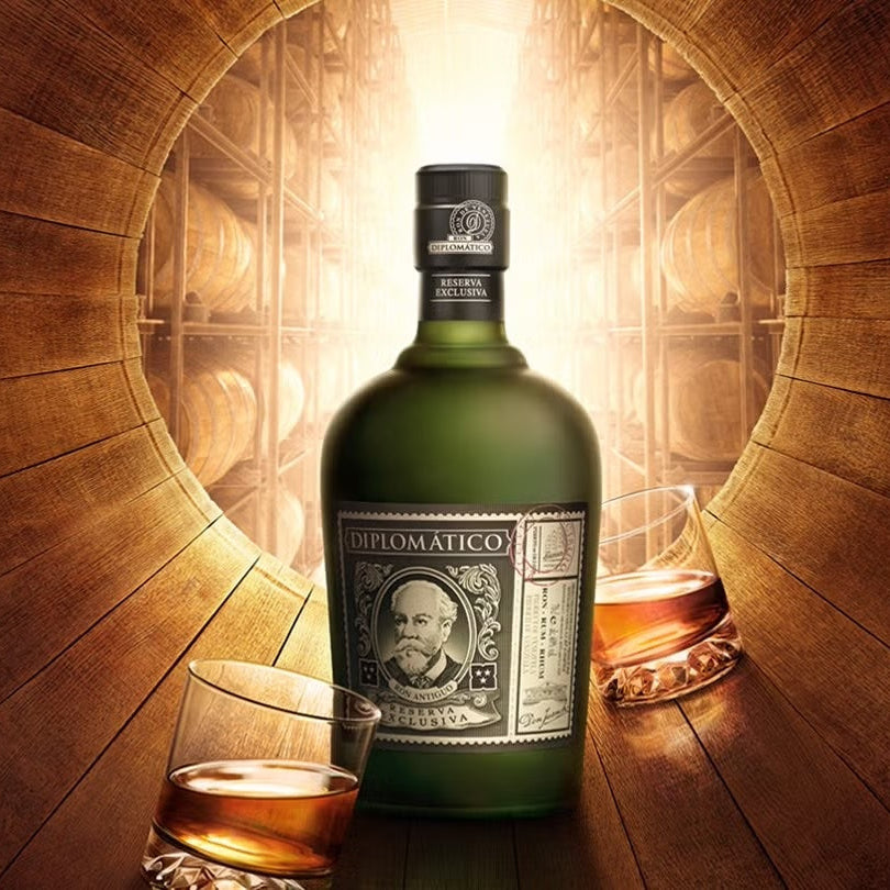 Load image into Gallery viewer, Bottle of Diplomatico Rumwith a glass on a wooden barrel background