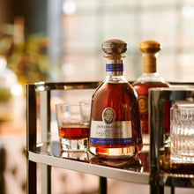 Load image into Gallery viewer, Bottle of Diplomatico vintage rum on a bar cart with blurred background