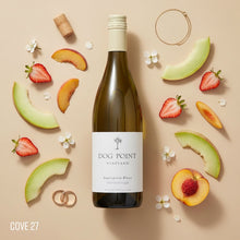 Load image into Gallery viewer, Dog Point Sauvignon Blanc wine bottle surrounded by fruit and flowers on a beige background